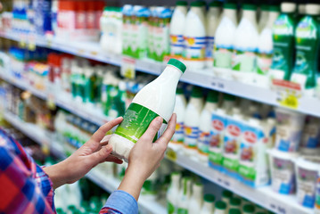 Woman shopping milk in store