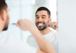 © Syda Productions - man with toothbrush cleaning teeth at bathroom