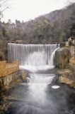 Fototapeta Paryż - Artificial waterfall on river Psyrtsha in Abkhazia New Afon