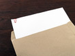 © andy0man - blank white paperwork with red clip in document envelope on desk floor