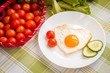 Fried egg in heart shape with vegetables