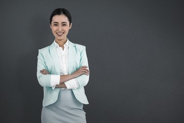 Poster - Composite image of elegant businesswoman with crossed arms 