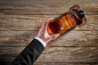 © goodmanphoto - overhead view of businessman holding a glass of whiskey