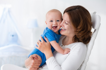 happy young mother with baby boy at home