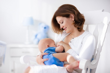 happy young mother with baby boy at home