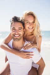 boyfriend giving piggy back to girlfriend