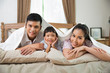 © torwaiphoto - Asian family happy Parents and children in bed