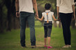 © torwaiphoto - Daughters, parents were holding hands in the park