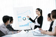© torwaiphoto - Business women are offered a job as a graph at a meeting of the
