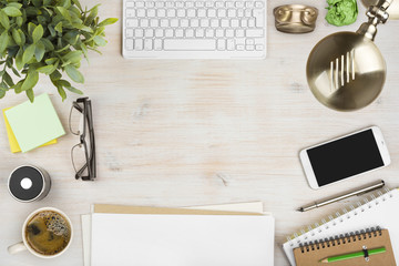 Wooden office desk top view with stationery and computer accessories