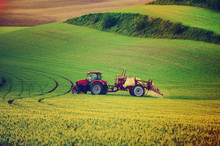 Farm Machinery Spraying Insecticide To The Green Field, Agricultural Natural Seasonal Spring Background, Vintag Retro Hipster Style