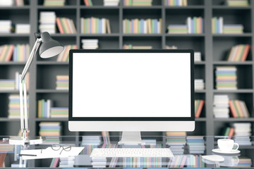 Poster - Blank computer screen on glassy table at bookshelf background, m
