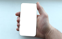 Smartphone In Male Hand On A Gray Background