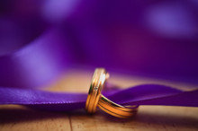 Wedding Rings And Purple Ribbon