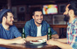 © Syda Productions - happy male friends drinking beer at bar or pub