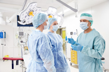 Wall Mural - group of surgeons in operating room at hospital