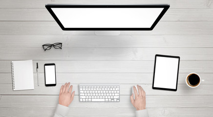 Poster - Responsive devices with isolated screen for mockup. Top view of modern desk with computer display, phone and tablet. Keyboard, coffee, glasses, notebook, pencil on table.