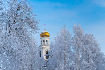 The golden dome of a Christian chapel on blue sky background