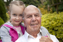 95 Years Old English Man With Granddaughter In Garden