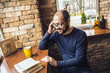 © sushytska - Handsome Man In Jeans Talking On Mobile Phone in Cafe Bar