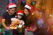 © torwaiphoto - Asian family opening a gift box on christmas day happy