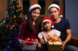 © torwaiphoto - Asian family gift giving and have a merry christmas. at night