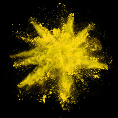 Wall Mural - Explosion of yellow powder on black background