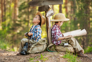 Boys on a forest road with backpacks