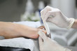 Close-up pedicure process of the big toe in spa salon. Professional work pedicure masters.