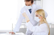 © rogerphoto - Scientific research team with clear solution in laboratory