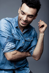 Wall Mural - Portrait of handsome young man in casual denim clothes standing over white background