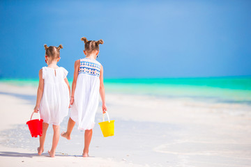 Wall Mural - Adorable little girls having fun during beach vacation