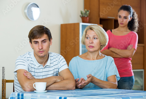 Fényképezés Angry wife and mother-in-law rebuking young man
