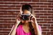 © WavebreakmediaMicro - Smiling asian woman taking picture with camera