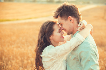 Young couple in love outdoor.Stunning sensual outdoor portrait of young stylish fashion couple posing in summer in field 