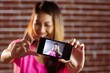 © WavebreakmediaMicro - Smiling asian woman taking selfie with smartphone