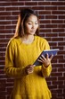 © WavebreakmediaMicro - Focused asian woman using tablet