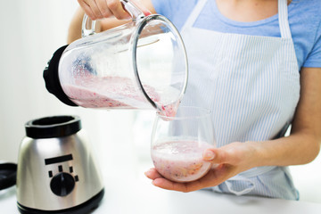 Wall Mural - close up of woman with blender and shake at home