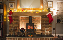 Christmas Stockings Hanging Up On The Mantelpiece, And A Carrot And Mince Pie Ready For Santa's Visit, 