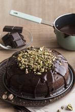 Preparind Chocolate Cake With Ganache And Pistachios