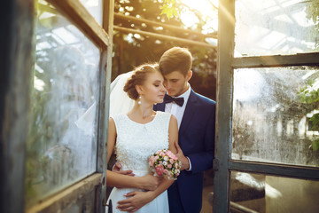 young wedding couple, beautiful bride with groom portrait on the sunset near the ears of wheat, summer nature outdoor