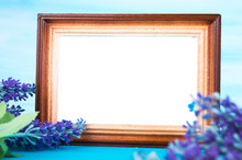 Wooden Photo Frame And Lavender Twig On A Blue Background