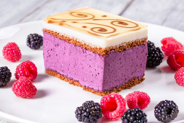 Canvas Print - a piece of cake souffle with blackberries, raspberries, closeup