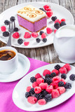 Fototapeta Mapy - a piece of cake souffle with blackberries, raspberries, closeup