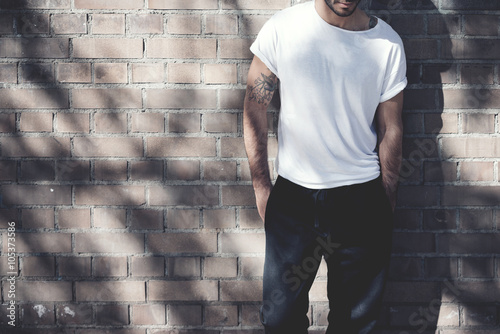 Download Photo Bearded Man With Tattoo Wearing Blank White Tshirt And Black Jeans Bricks Wall Background Wide Mockup Stock Photo Adobe Stock