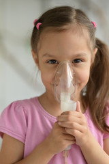 Wall Mural - Lovely little girl with inhaler