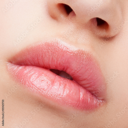 Stampe Close-up shot of female lips with healthy skin and rose color li
