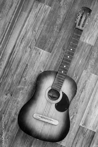 Fototapeta na wymiar Acoustic guitar on wooden background