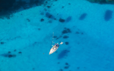 Wall Mural - Aerial view of single yacht in azure sea