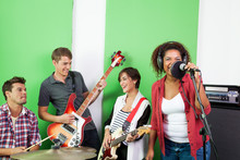 Band Members Performing In Recording Studio